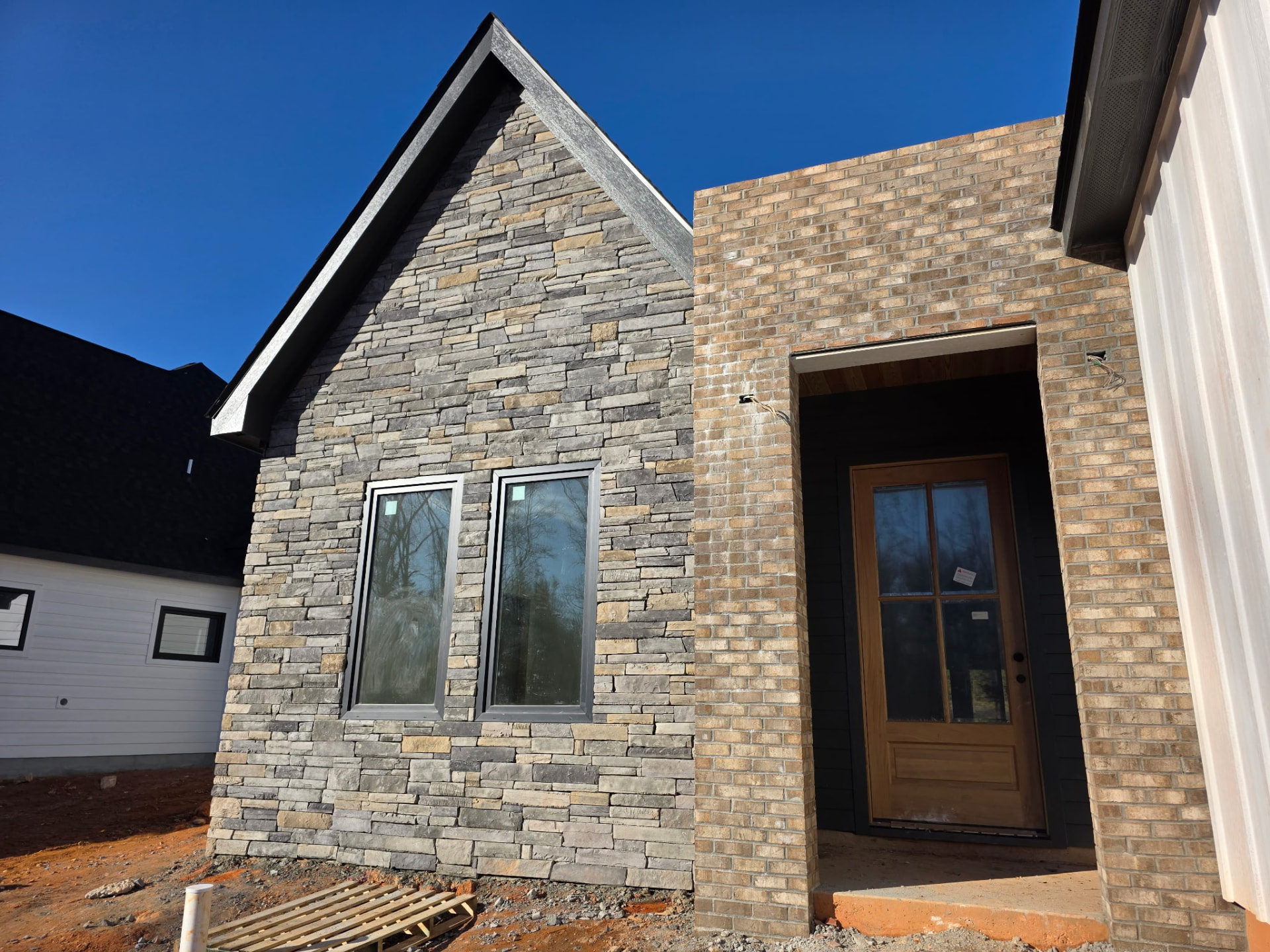 Natural stone veneer installed on the front elevation of a residential home