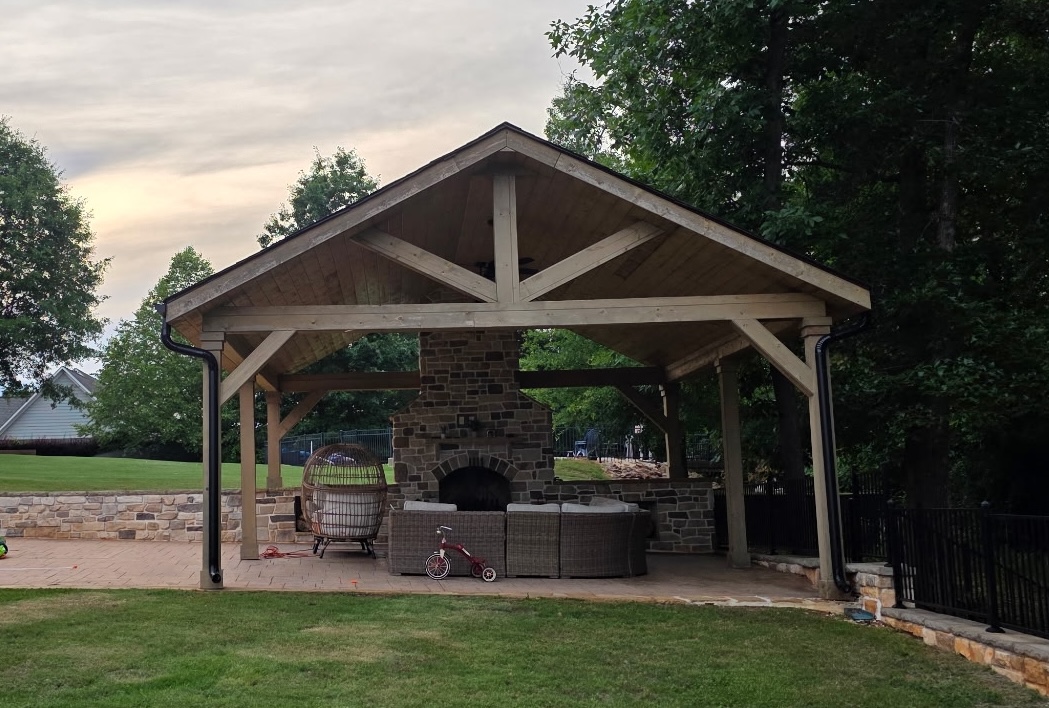 Covered timber pavilion with a masonry outdoor fireplace